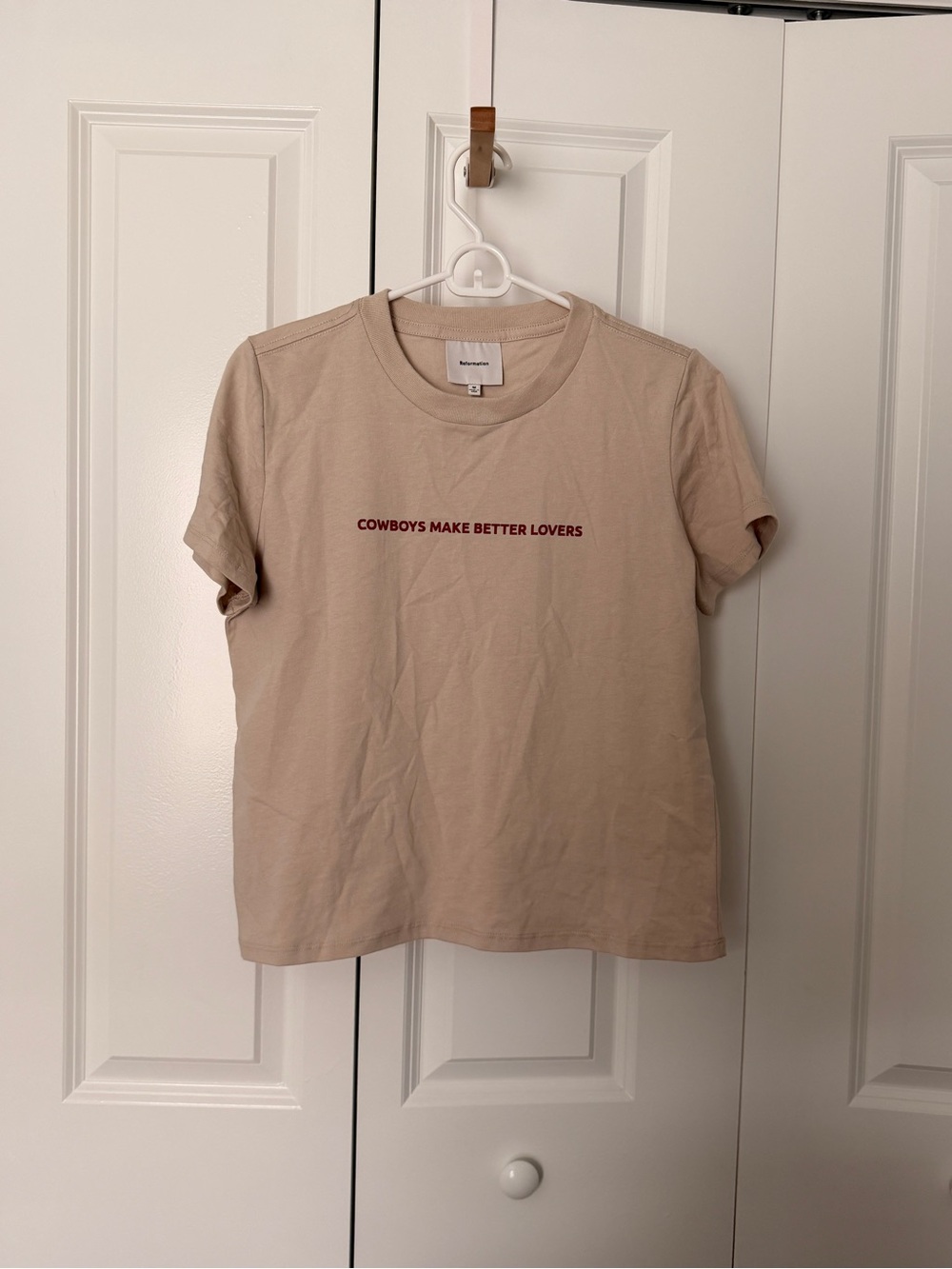 Reformation beige tee with red chest text